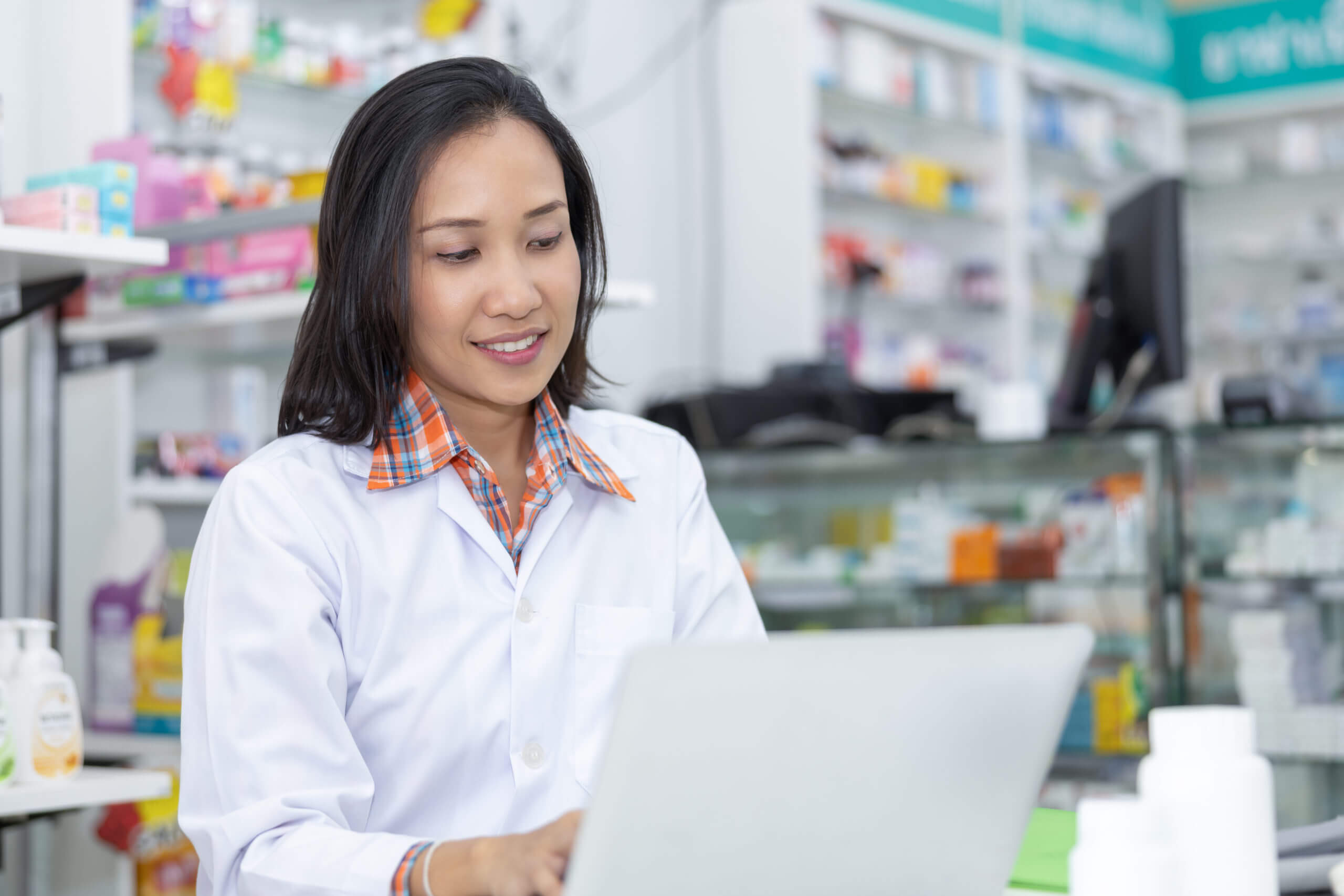 pharmacist checking data medicine on computer laptop